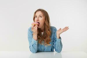 Photo of young pretty woman which is going to bite off a delicious kidney, isolated over white background.