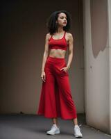 AI generated Beautiful young brunette woman in a red sports top and leggings posing. ai generative photo