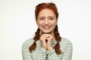smiling ginger young female starring into camera photo