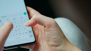 Female hands typing text on smartphone close-up. video