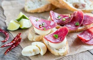 Ciabatta sandwiches with fuet and mini cheese photo