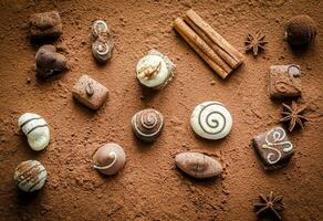 Luxury chocolate candies with cocoa background photo