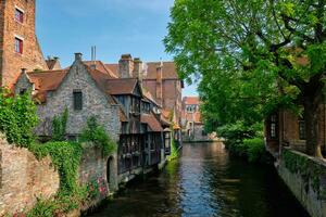 Canal with old houses in Bruge, Beligum photo