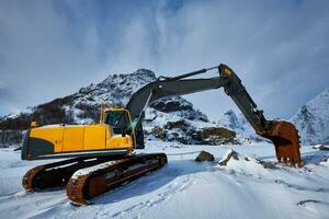 Old excavator in winter photo