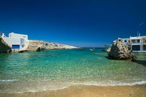 Crystal clear blue water at MItakas village beach, Milos island, Greece. photo