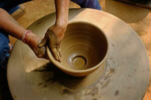 Indian potter hands at work, Shilpagram, Udaipur, Rajasthan, India photo