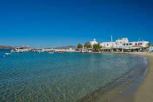 The beach and fishing village of Pollonia in Milos, Greece photo