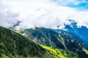 Landscape in the Himalayas Panoramic view from the top of Sonmarg, Nepal's Kashmir valley in the Himalayan region. Grasslands, wildflowers and mountain snow. hiking concept Nature camping, India photo