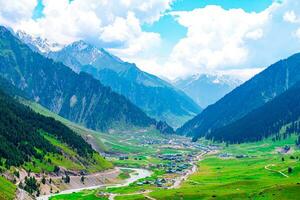 Landscape in the mountains. Panoramic view from the top of Sonmarg, Kashmir valley in the Himalayan region. meadows, alpine trees, wildflowers and snow on mountain in india. Concept travel nature. photo