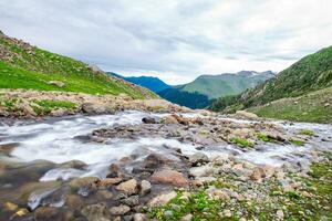 Landscape in the Himalayas Panoramic view from the top of Sonmarg, Nepal's Kashmir valley in the Himalayan region. Grasslands, wildflowers and mountain snow. hiking concept Nature camping, India photo