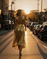 ai generado hermosa joven mujer en un largo amarillo vestir caminando en el calle a puesta de sol. ai generativo foto