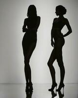 AI generated Silhouette of three women in black and white dresses, studio shot. ai generative photo