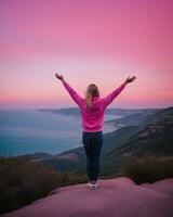 AI generated young woman hiker open arms on top of a mountain at sunrise. ai generative photo