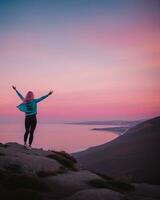 AI generated young woman hiker open arms on top of a mountain at sunrise. ai generative photo