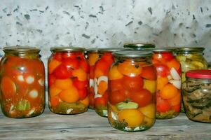 Jars of a variety of pickled vegetables . Canned foods. Preserves photo