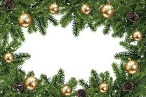 Branches of a natural Christmas tree with yellow balls  and cones on a white background. Isolated image. Christmas tree branches frame photo