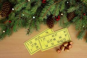 Christmas background. Christmas tree branches, cones of a lotto card with numbers and barrels. Success and good luck. photo