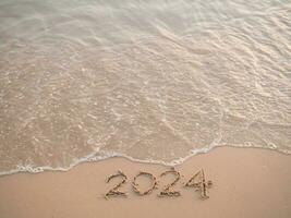 2024 year written on the beach in the sunset time. New Year 2024 concept photo