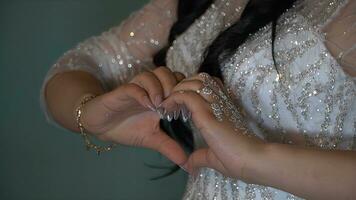 Close-up of beautiful bride's hands with wedding rings on her finger photo