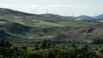 Wind turbines energy moving at mediterranean landscape at sunset video