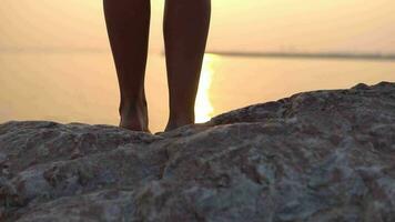 Close-up. A long dress develops in the wind against the background of the sunset. slow motion video