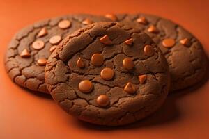 ai generado chocolate chip galletas en naranja antecedentes. cerca arriba. selectivo enfocar. ai generativo foto