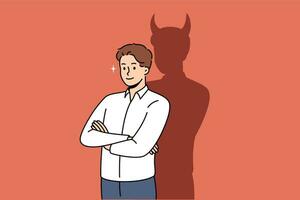 Confident businessman with bad thoughts stands with arms crossed near shadow with devil horns vector