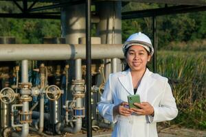 Environmental engineer in white helmet working at wastewater treatment plant. Water supply engineering working at Water recycling plant for reuse. Water and ecology concept. photo