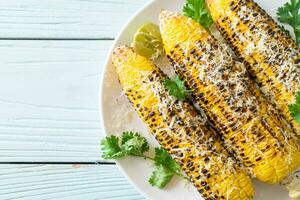 barbecue and grilled corn with cheese and lime photo