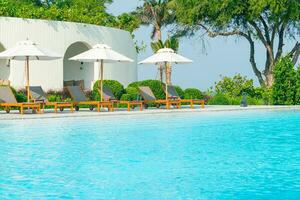 umbrella with bed pool around swimming pool with ocean sea background photo