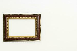 empty picture frame on white wall background photo