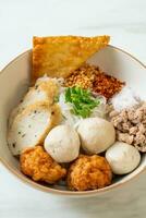 spicy small flat rice noodles with fish balls and shrimp balls without soup photo