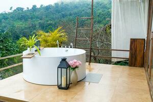 outdoor bath tub with beautiful mountain view background photo