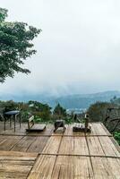 chair on balcony with mountain hill and foggy background photo