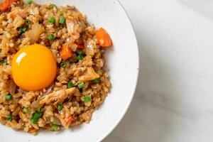 salmon fried rice with pickled egg on top photo