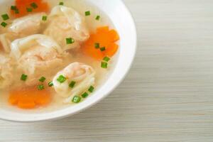 shrimp dumpling soup in white bowl photo
