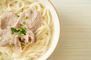 udon noodles with pork in clear soup photo