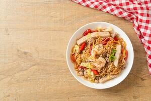 Instant noodles spicy salad on plate photo