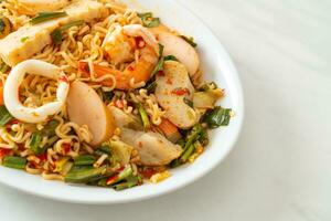 Instant noodle spicy salad with mixed meats photo