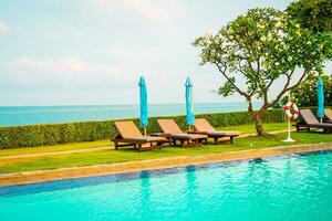 chair pool and umbrella around swimming pool photo