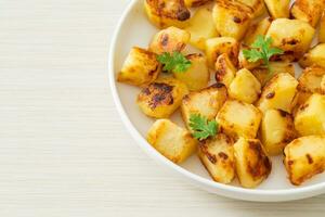 Roasted or grilled potatoes  on plate photo