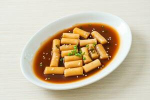 Spicy Jjajang Tteokbokki or Korean rice cake in spicy black bean sauce photo