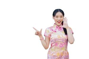 Asian woman with long hair who wears pink Cheongsam dress in Chinese new year theme while her hand shows to present something and showing hand to point while isolated on white background. photo