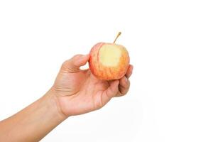 Hand holding bite red apple isolated on white background. Ripe red apple in human hand. photo