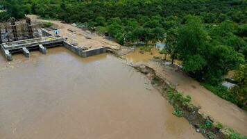 Flooding the floodgate construction, unfinished construction. The river bank collapsed due to heavy rain and strong water flow. photo