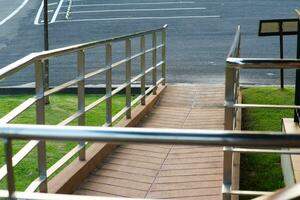 Stone ramp way with stainless steel handrail for support wheelchair disabled people. photo