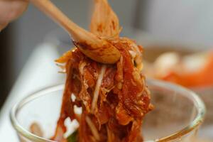 Step-by-step procedures to marinate pork for easy Korean cooking, add chopped onions and Japanese bunching onion, sesame oil, soy sauce, Korean gochujang and mix well. Korean homemade food for lunch photo