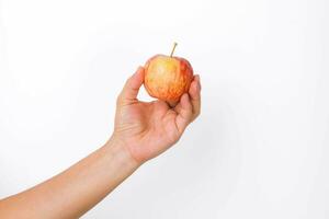 Hand holding red apple isolated on white background. Ripe red apple in human hand. photo