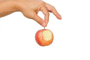 Hand holding bite red apple isolated on white background. Ripe red apple in human hand. photo