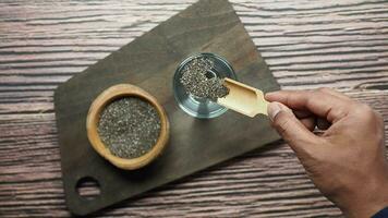 top view of chia seeds pouring in a glass of water video